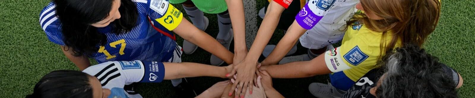 Frauenfußball-WM 2023: Spielerinnen vereinen Hände in einem Kreis.