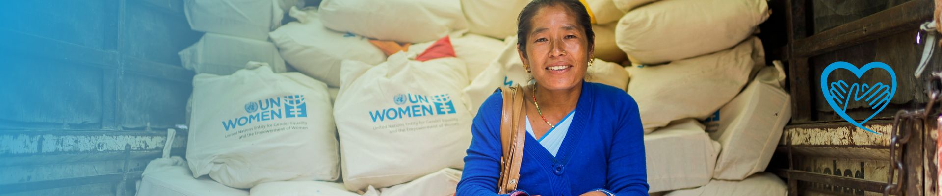 Frau sitzt in einem LKW mit Hilfsgütern von UN Women - Für UN Women Projekte spenden