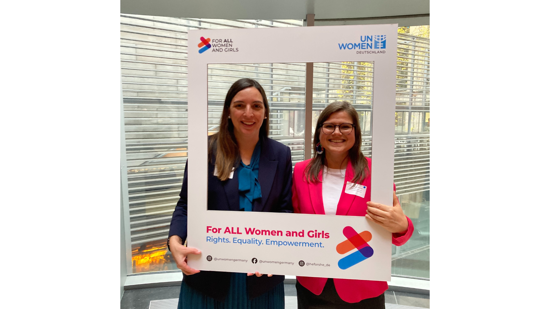 Uta Hergenroether and von Wartenberg posing with a sign with the text
