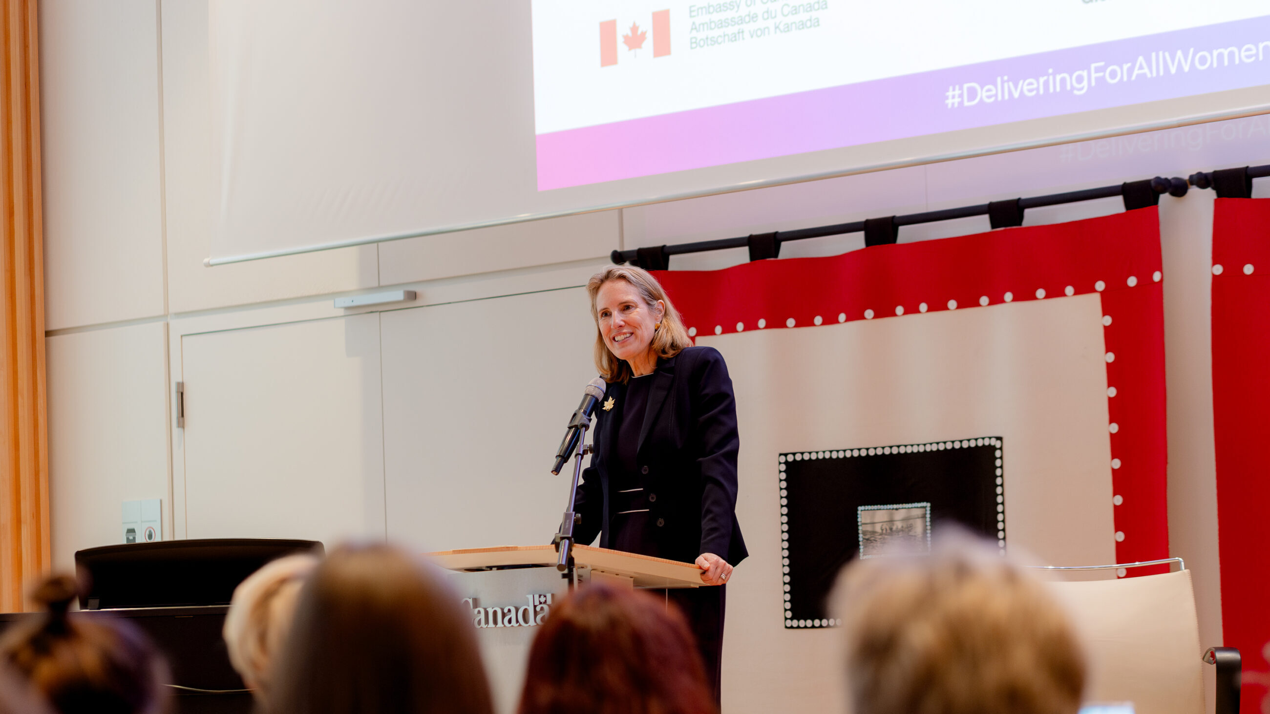 Evelyne Coulombe on stage at the international conference presenting her welcoming remarks.