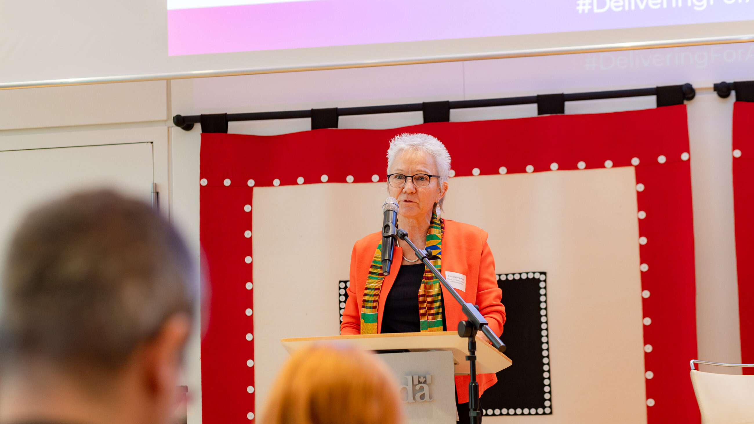 Dr. Angela Langenkamp on stage at the international conference presenting her welcoming remarks.